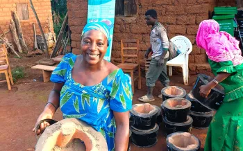 woman holding efficient cookstove